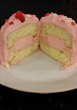 A picture of Vanilla Butter Cakes filled and Frosted with Whipped White Chocolate Rasberry Ganache.