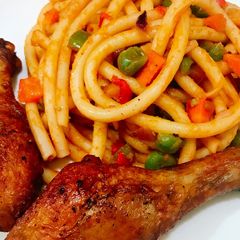 A picture of Veggy Pasta and fried chicken drumsticks.