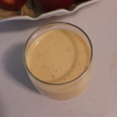 Mango banana smoothie with a hand full of nuts A picture of Mango banana smoothie with a hand full of nuts.