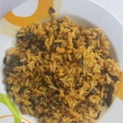 A picture of Jallof rice with moringa leaf.