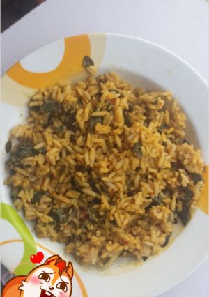 A picture of Jallof rice with moringa leaf.