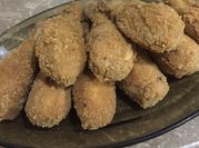 A picture of breaded chicken drumsticks
