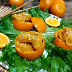 A picture of Orange Chicken with fried rice.