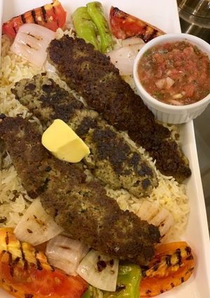 A picture of Chullu kabab with butter saffron rice.