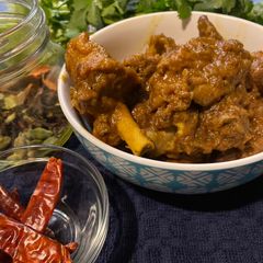 A picture of Country style chicken with chili (murghir laal jhol).