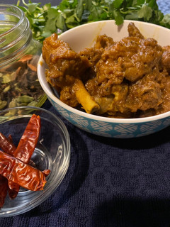 A picture of Country style chicken with chili (murghir laal jhol).