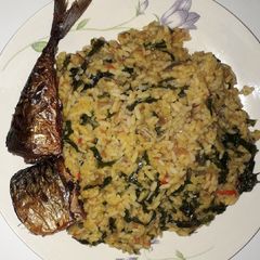 A picture of Vegetable palm oil rice with fried fish.