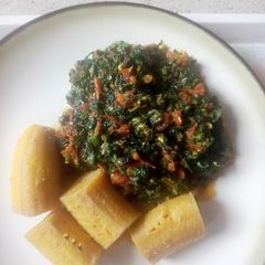 A picture of Boiled unripe plantain with veg sauce.