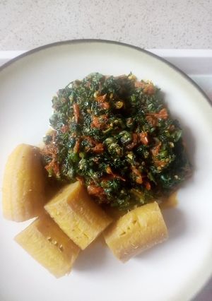 A picture of Boiled unripe plantain with veg sauce.