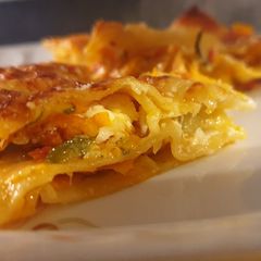 A picture of Lasagna with zucchini and carrot.