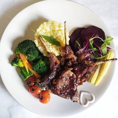 A picture of Creamy samp with lamb chops and steamed veggies.