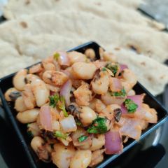 A picture of Black Eyed Beans dry sabzi with Jowar Roti.