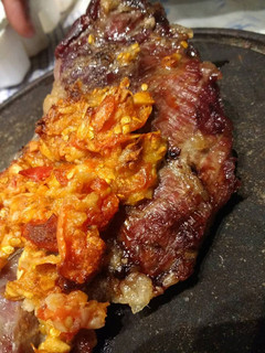 Una foto de Carne asada con pasta de ajo y tomate