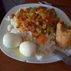 White rice with turmeric, tomatoes sauce & Egg A picture of White rice with turmeric, tomatoes sauce & Egg.