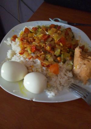 A picture of White rice with turmeric, tomatoes sauce & Egg.
