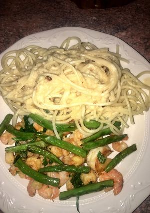 A picture of Shrimp, greens and pasta.