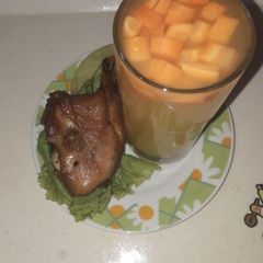 A picture of Orange juice with carrot bite.
