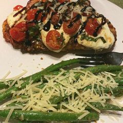 A picture of Bruschetta Chicken with Garlicky Parmesan Green Beans.