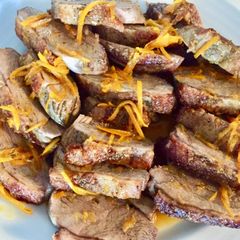A picture of Duck breasts fillet with orange sauce.
