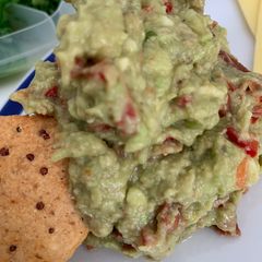 A picture of Guacamole with sun dried tomatoes.