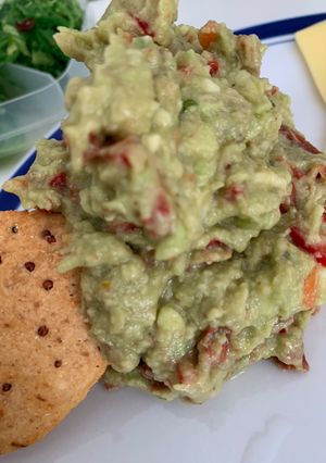 A picture of Guacamole with sun dried tomatoes.