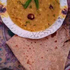 A picture of Desi Masar and moong daal Mix on wood fire.