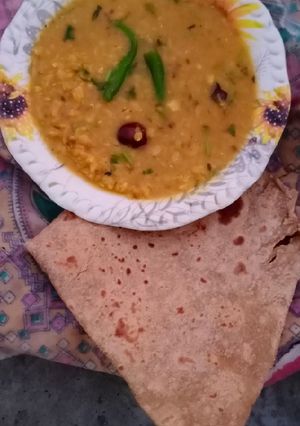 A picture of Desi Masar and moong daal Mix on wood fire.