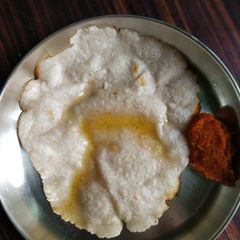 A picture of White roti with onion chutney.