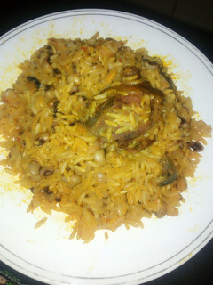 A picture of Jollof palm oil rice and beans.