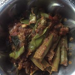 A picture of Brinjal and drumstick curry.