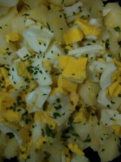 A picture of Potatoes and eggs salad.