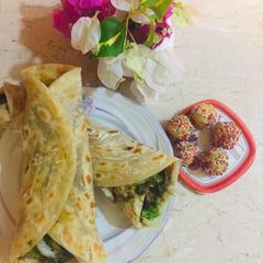 A picture of Reshmi kaba roll paratha,with barfi laddo(laddo).