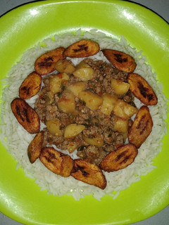 A picture of White rice and plantain with minced meat sauce.