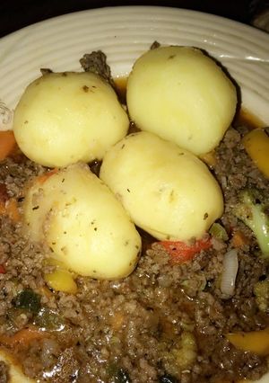 A picture of Boiled potatoes and minced meat sauce. Yes.