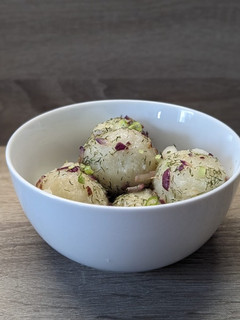 A picture of Pierogi with Sour Cream.