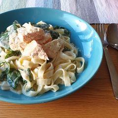 A picture of Salmon pasta with spinach.
