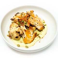 A picture of Grilled Cauliflower with Avocado Cilantro Aioli and Toasted Paprika Breadcrumbs.