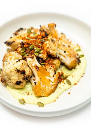 A picture of Grilled Cauliflower with Avocado Cilantro Aioli and Toasted Paprika Breadcrumbs.