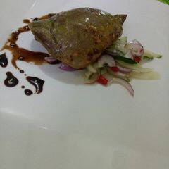 A picture of Roasted beef heart with cucumber salad and garlic soy reduc.