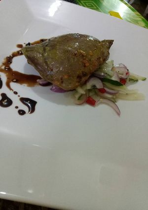 A picture of Roasted beef heart with cucumber salad and garlic soy reduc.