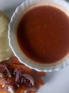 A picture of Oven baked carrot strips with smooth mashed potatoes and homemade garlic tomato sauce.