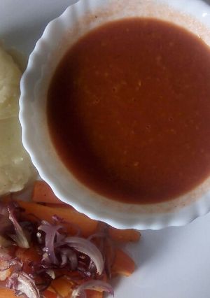 A picture of Oven baked carrot strips with smooth mashed potatoes and homemade garlic tomato sauce.