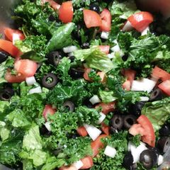 A picture of Kale and romaine lettuce salad.