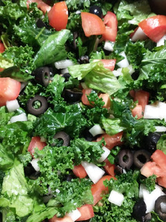 A picture of Kale and romaine lettuce salad.