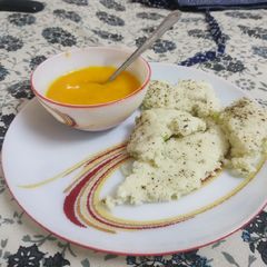 White dhokla and Aamras A picture of White dhokla and Aamras.