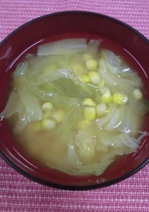 A picture of Miso soup with corn and cabbage.