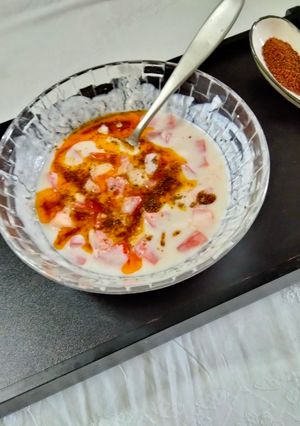 A picture of Tomato Raita seasoned with Mustard seeds.