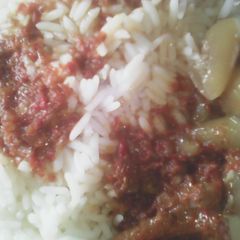 A picture of White rice wit ganda soup.