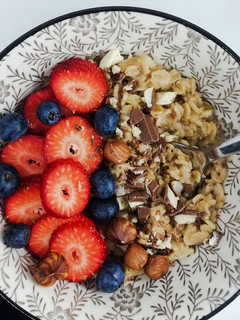 A picture of Oatmeal with Berries, Chocolate, and Hazelnuts.