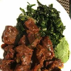 A picture of Wet fry liver served with saute kales.